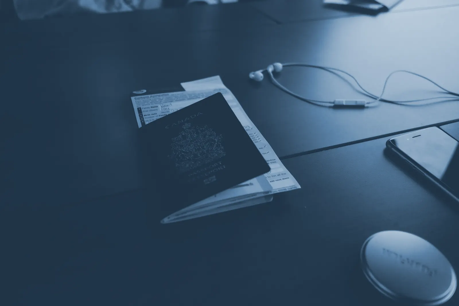 A passport and identity papers on a desk.