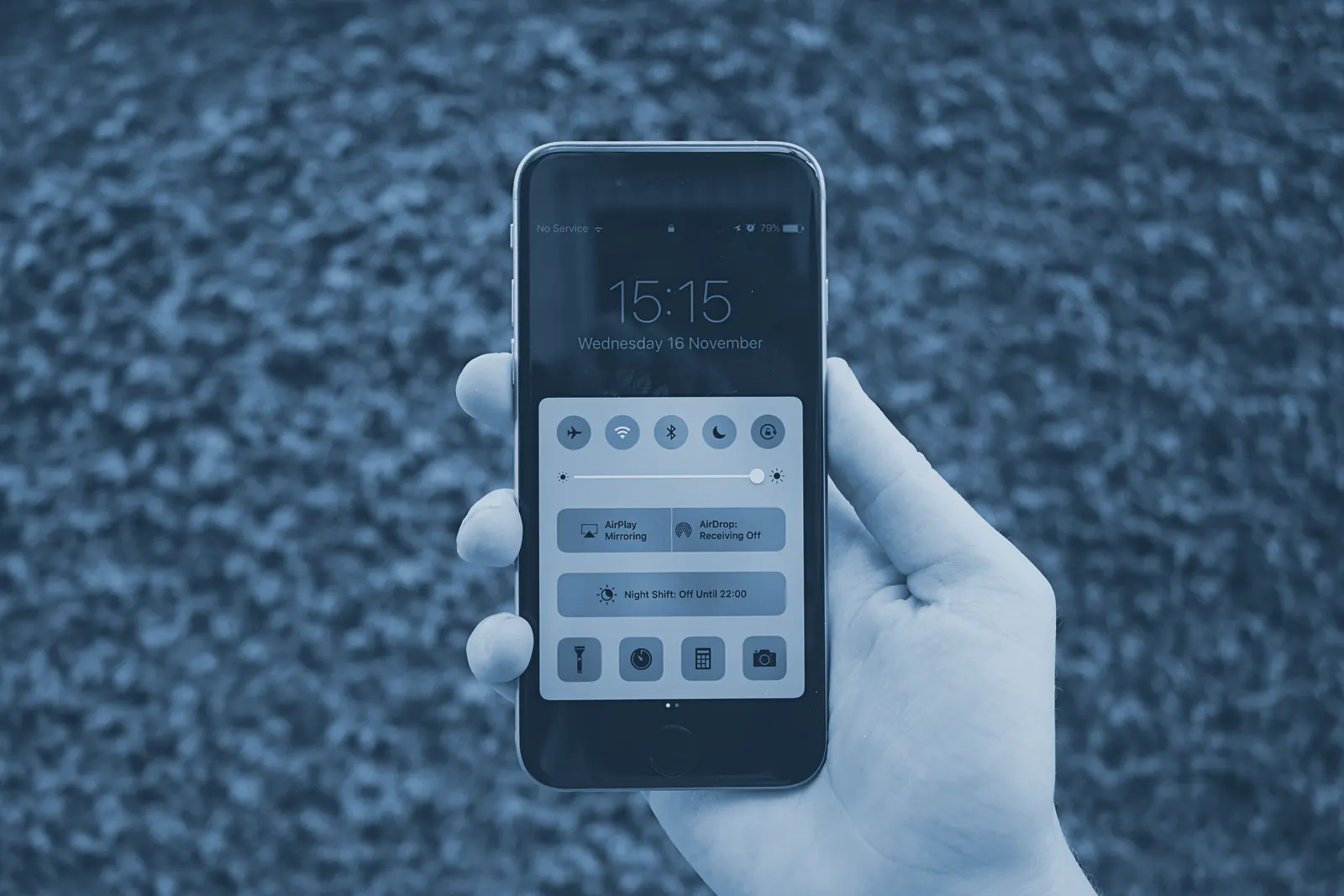 A hand holding a smartphone.